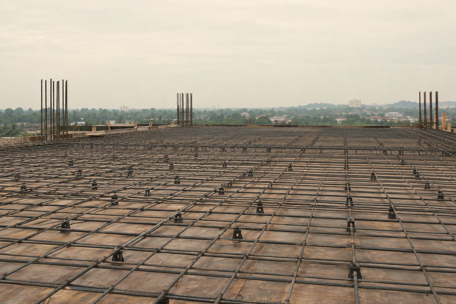 Steel mesh laid on chairs across a suspended slab, ready for the concrete pour